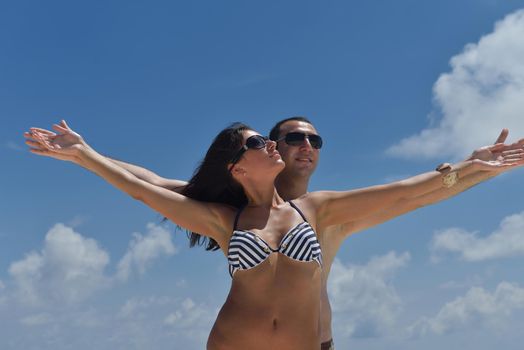 happy young romantic couple in love have fun and relaxing on beautiful beach