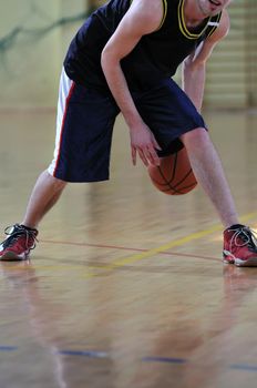 one healthy young  man play basketball game in school gym indoor