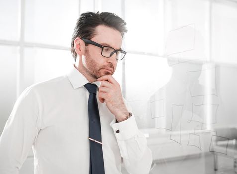 serious businessman standing in the office.photo with copy space