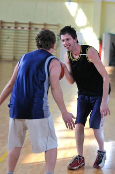 competition cencept with people who playing basketball in school gym