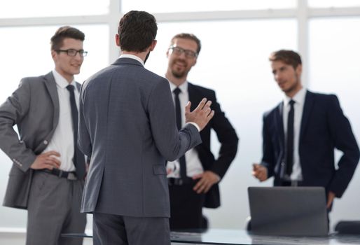 boss talking to employees standing in the office.photo with copy space