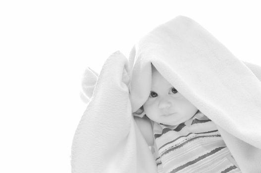 cute little baby isolated on white under blanket alone
