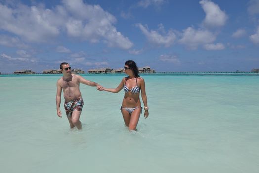 happy young romantic couple in love have fun and relaxing on beautiful beach