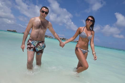 happy young romantic couple in love have fun and relaxing on beautiful beach