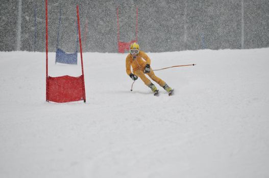 young skier race fast downhil at winter snow scene 