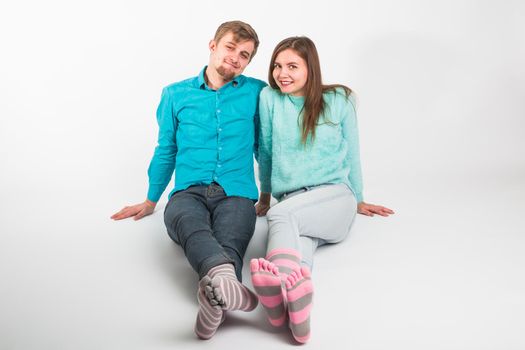 Portrait funny moments of excited couple fooling around to camera on white background. Having fun, weekends and valentines day concept.