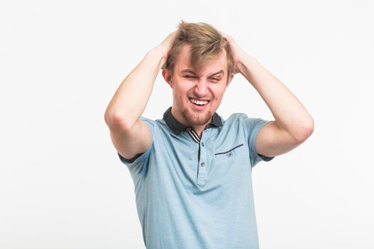 Stressed Young Man Clutching the Head in white background