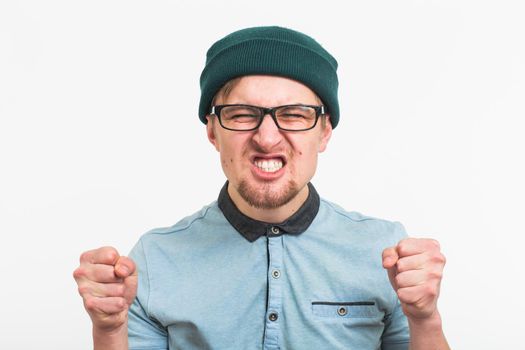 Angry aggressive man with ferocious expression on white background