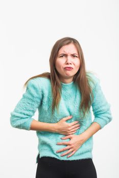 Woman with stomach pain on blue background.