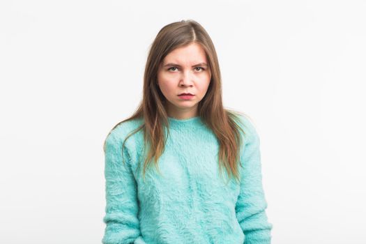 Portrait of angry woman standing on white background.