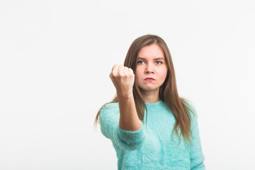 Angry aggressive woman with ferocious expression on white background.