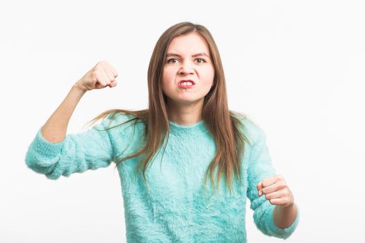 Angry aggressive woman with ferocious expression on white background.