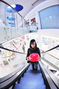 happy young woman shopping in big modern city mall