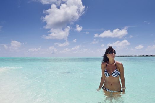 beautiful and happy young woman on beach have fun and relax on summer vacation  over the crystal clear sea