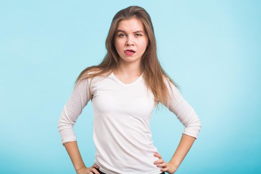 Funny beautiful young woman have fun over blue background