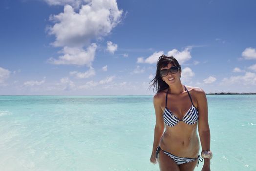 beautiful and happy young woman on beach have fun and relax on summer vacation  over the crystal clear sea