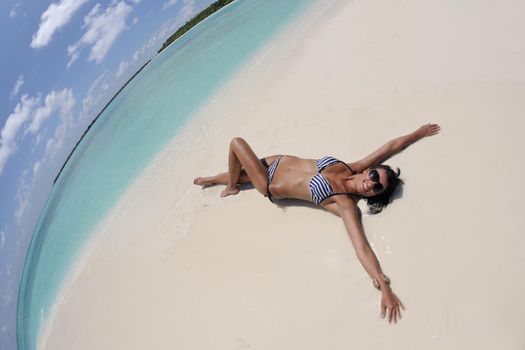 beautiful and happy young woman on beach have fun and relax on summer vacation  over the crystal clear sea