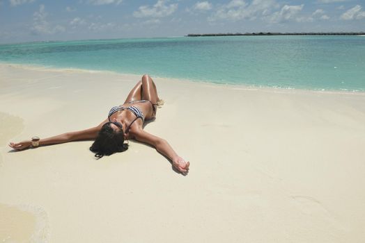 beautiful and happy young woman on beach have fun and relax on summer vacation  over the crystal clear sea