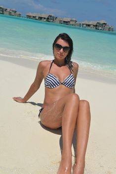 beautiful and happy young woman on beach have fun and relax on summer vacation  over the crystal clear sea