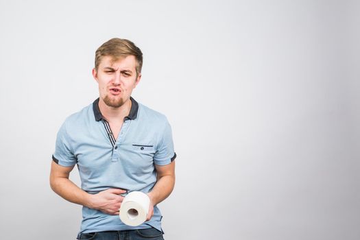 Young Man with Toilet Paper on the White Background - health problem concept.