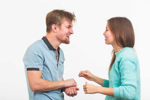 Happy couple or marriage looking each other laughing over white background.