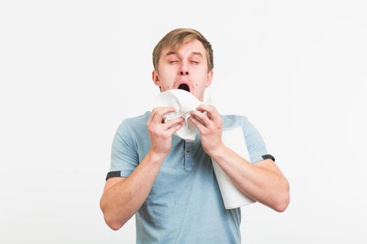 Man Sneezing Studio Portrait Concept. Young man with handkerchief. Sick guy isolated has runny nose