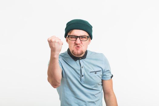 Angry aggressive man with ferocious expression on white background
