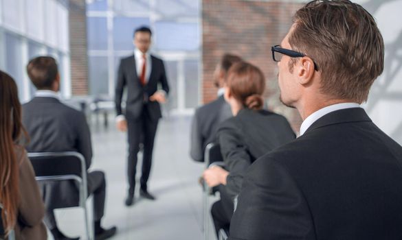 rear view. the listener is sitting at a business seminar.business concept