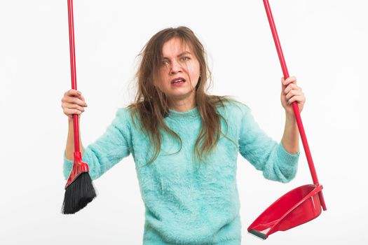 Woman or housewife holding broom, tired to cleaning, on white background, isolated with copy space