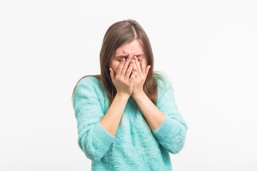 A sad beautiful woman crying on white background