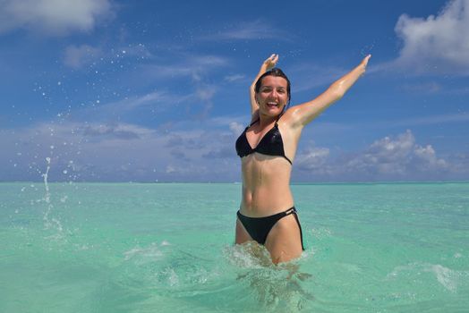 happy young woman on summer vacation on beautiful tropical beach have fun enjoy and relax