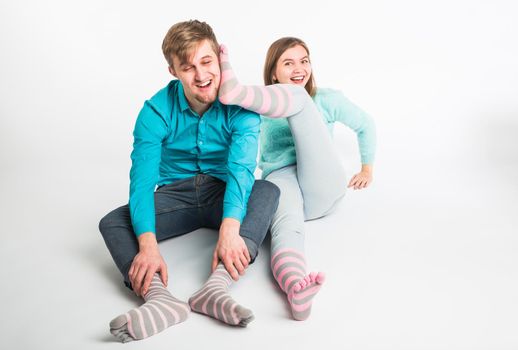 Portrait funny moments of excited couple fooling around to camera on white background. Having fun, weekends and valentines day concept.