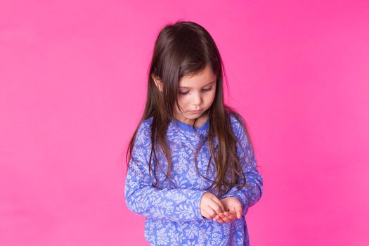 Pretty cute little girl on pink background