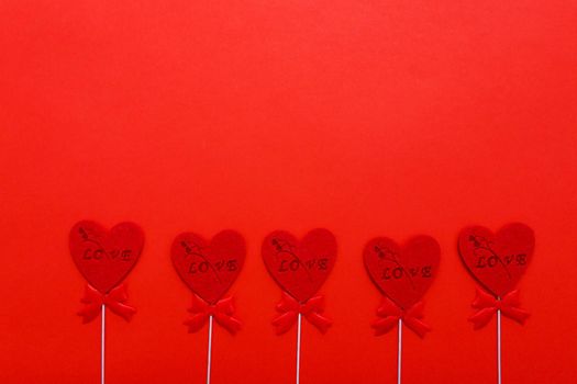 Red hearts on red background for valentines day. Holidays, love and romance.