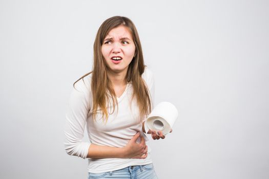 Woman with toilet paper and problems with her digestive system.