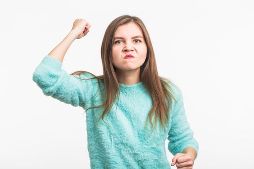 Angry aggressive woman with ferocious expression on white background.