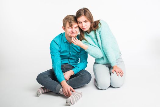 Portrait funny moments of excited couple fooling around to camera on white background. Having fun, weekends and valentines day concept.