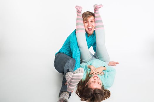 Portrait funny moments of excited couple fooling around to camera on white background. Having fun, weekends and valentines day concept.