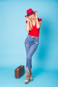 Summer, travel and holidays concept - girl going on a journey, blue background.