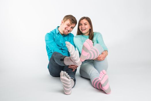 Portrait funny moments of excited couple fooling around to camera on white background. Having fun, weekends and valentines day concept.