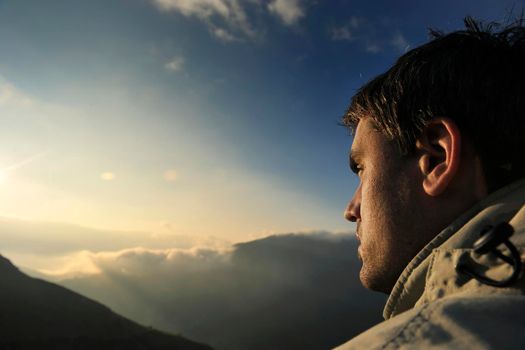 healthy young man practice yoga in height mountain at early morning and sunrise