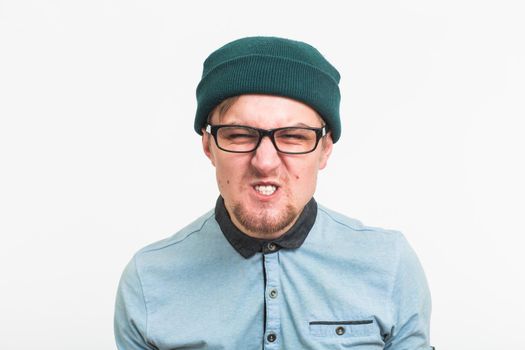 portrait of young angry man on white background.