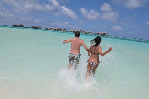 happy young romantic couple in love have fun and relaxing on beautiful beach