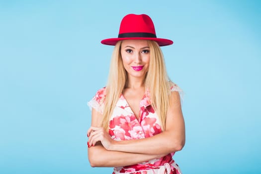 Portrait of happy cheerful smiling young beautiful blond woman on blue background.