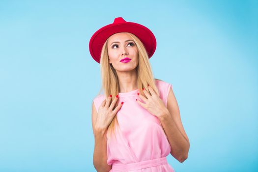 Beautiful woman with long straight blond hair. Fashion model posing at studio.