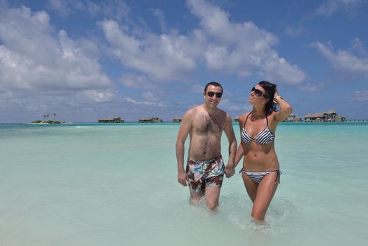 happy young romantic couple in love have fun and relaxing on beautiful beach