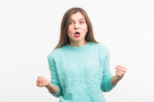 portrait of young angry woman on white background.