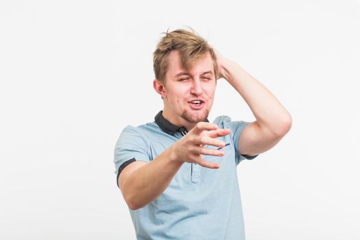 Funny attractive young man pointing a finger towards you.