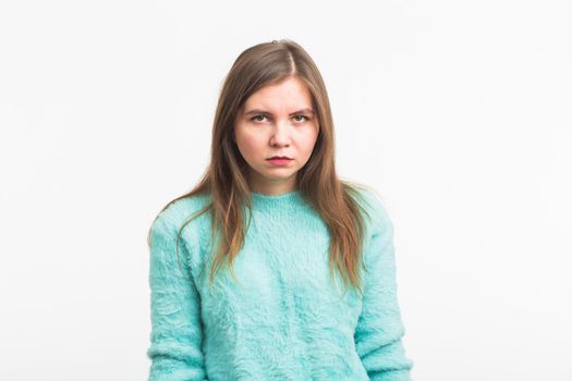 Portrait of angry woman standing on white background.