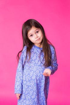 Portrait of a charming brunette little girl, isolated on gray background